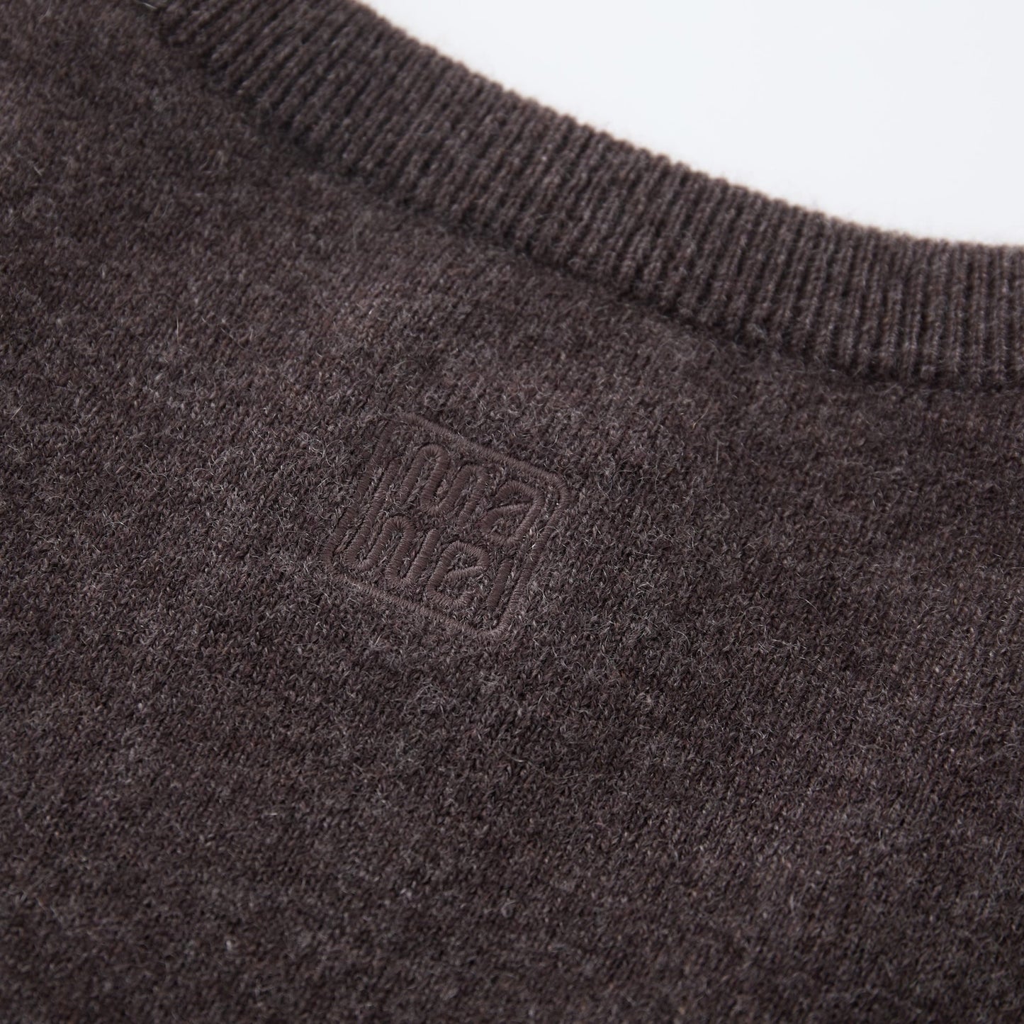 MA07 Cashmere Short Sleeve Crewneck Sweater by Mawei, brown, fabric and logo embroidery close-up, back view.