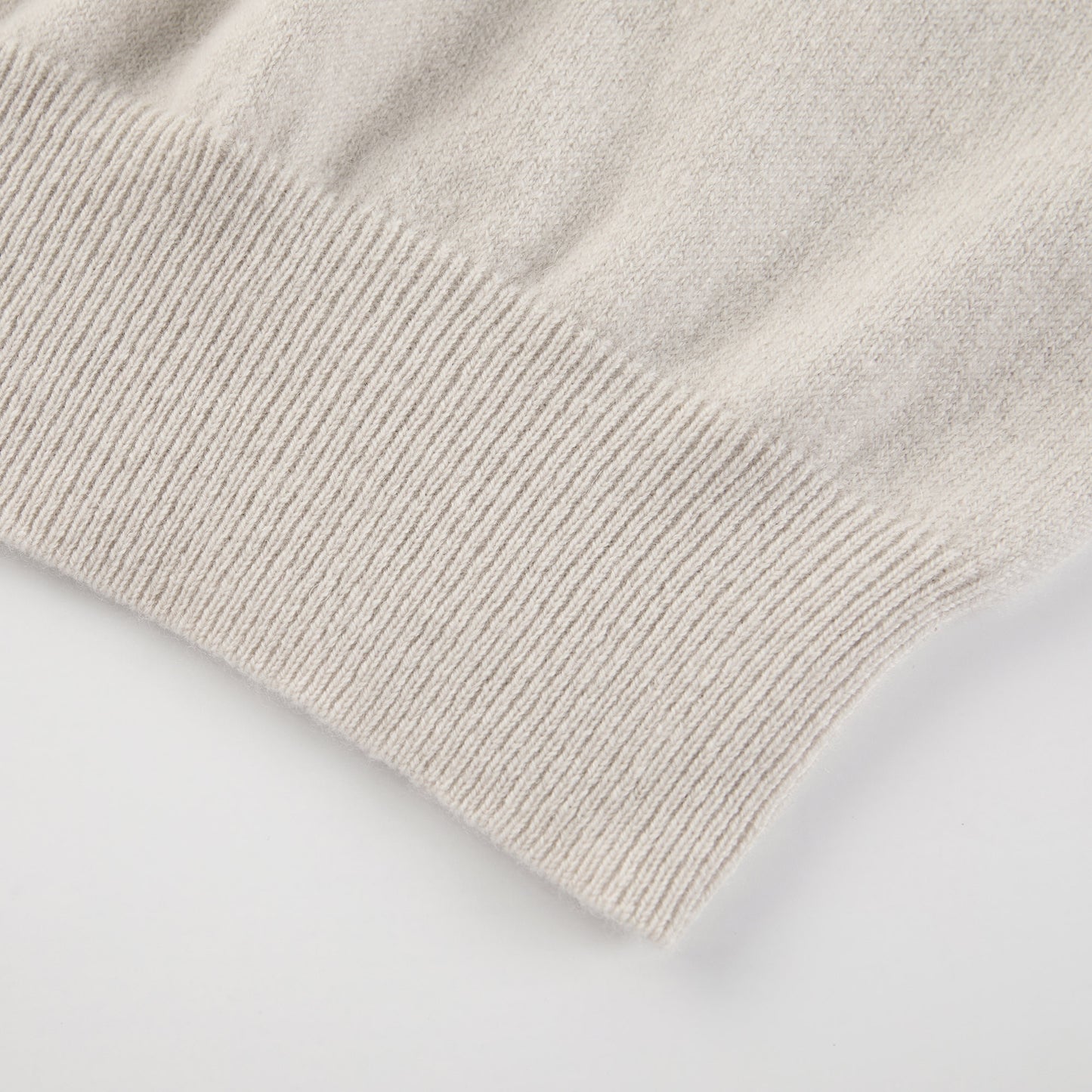 MA03 Cashmere Short Sleeve Crewneck Sweater by Mawei, off white, hem rib detail close-up.