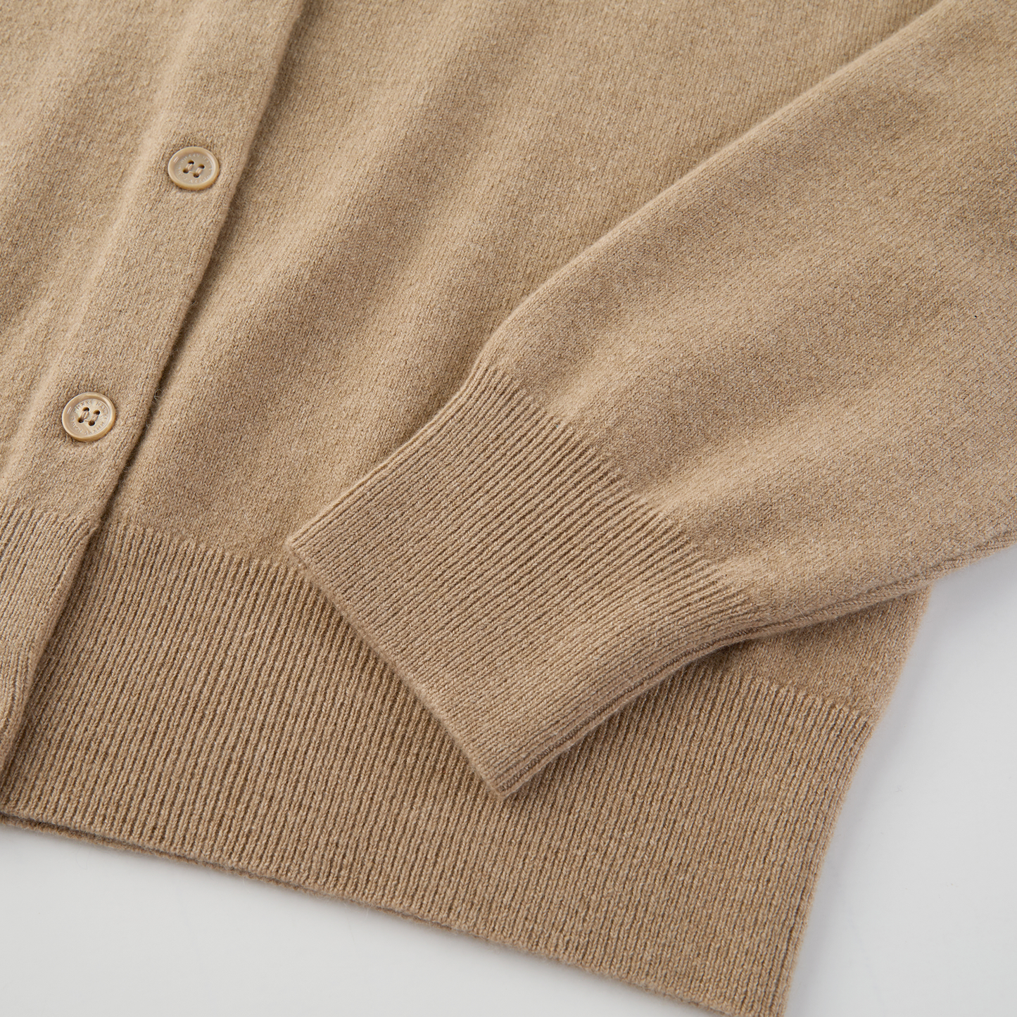 MA06 Cashmere Crewneck Cardigan by Mawei, beige camel, hem, cuff rib detail close-up.