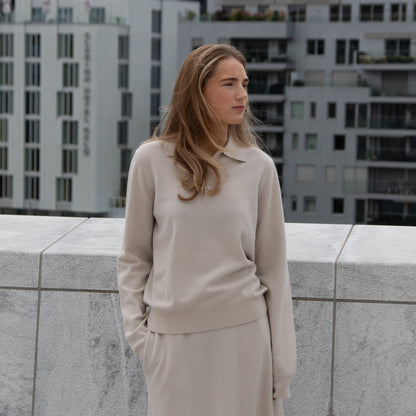 MA34 Cashmere A‑Line Skirt and MA25 Cashmere Polo Sweater by Mawei, off white, front view, female model.