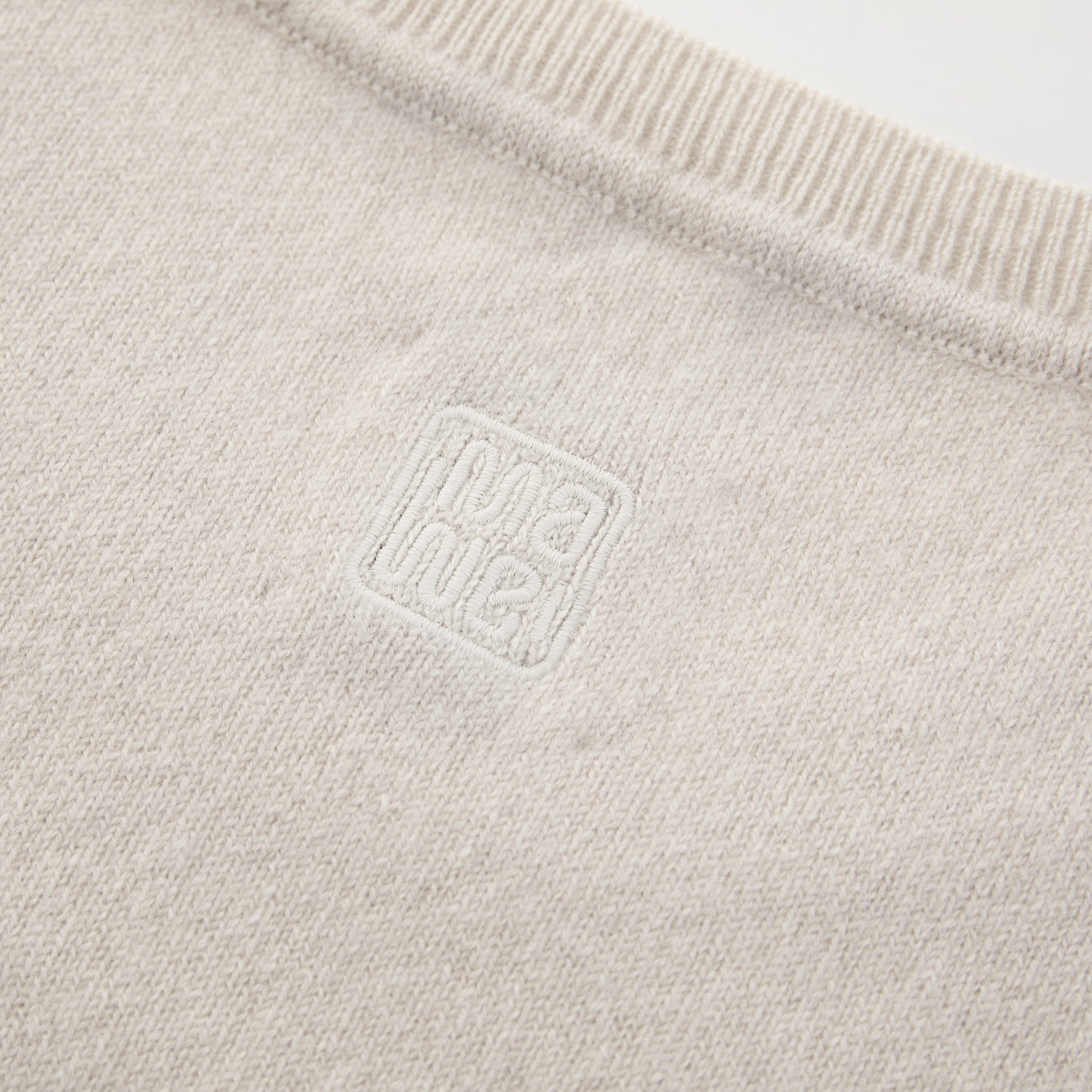 MA03 Cashmere Short Sleeve Crewneck Sweater by Mawei, off white, fabric and  logo embroidery detail, close-up, back view.