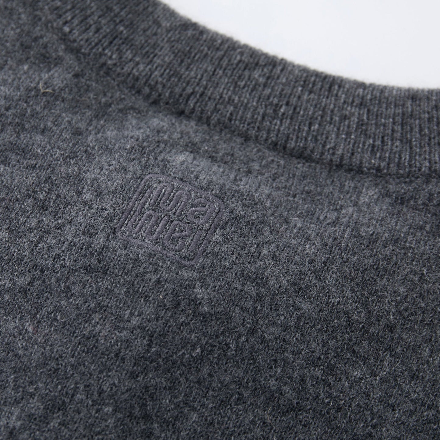 MA06 Cashmere Crewneck Cardigan by Mawei, grey,  fabric and logo embroidery close-up, back view.