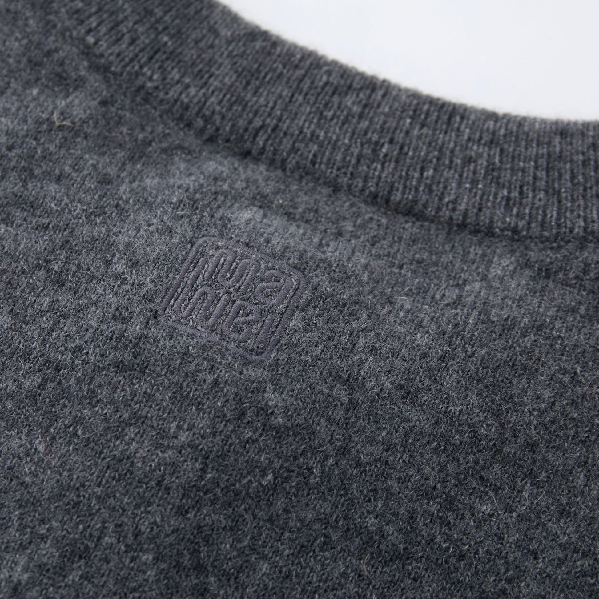 MA06 Cashmere Crewneck Cardigan by Mawei, grey,  fabric and logo embroidery close-up, back view.