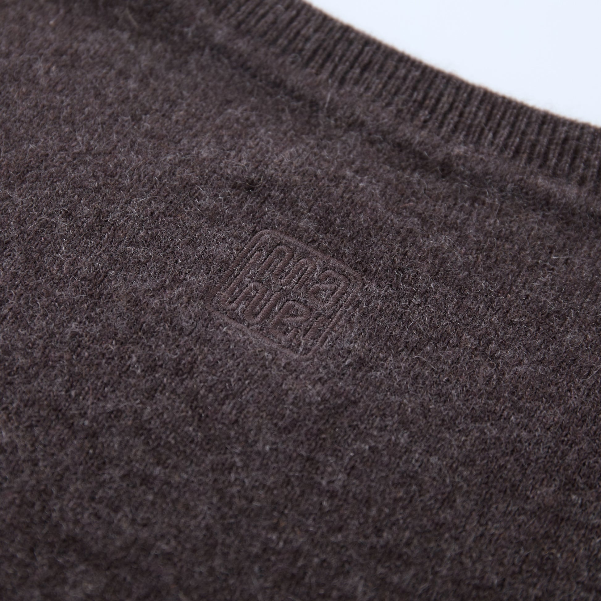 MA08 Oversized Cashmere V-neck Sweater by Mawei, brown, fabric and logo embroidery  close-up, back view.