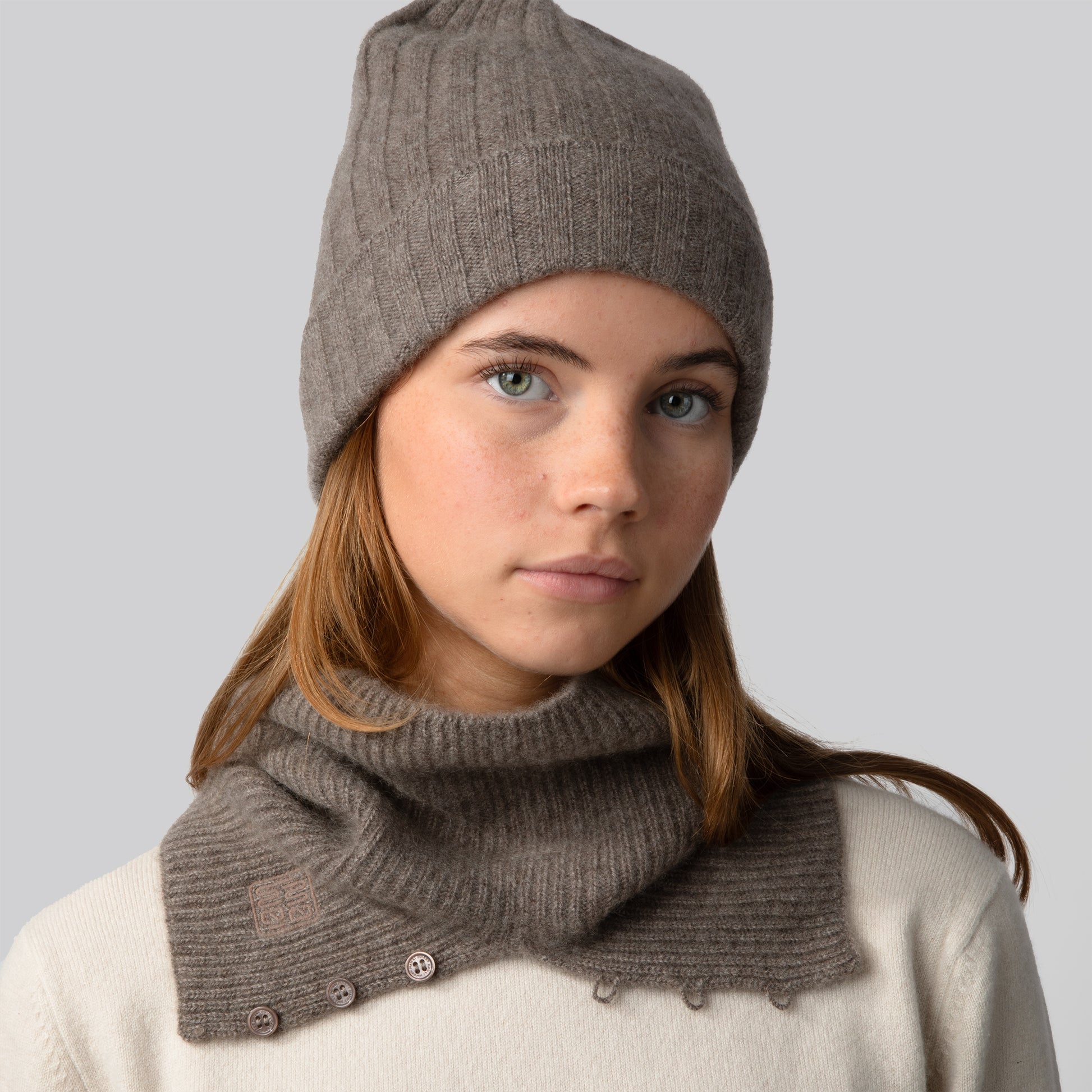MA71 Cashmere Beanie, MA61 Cashmere Buff by Mawei, grey brown, front view, female model.