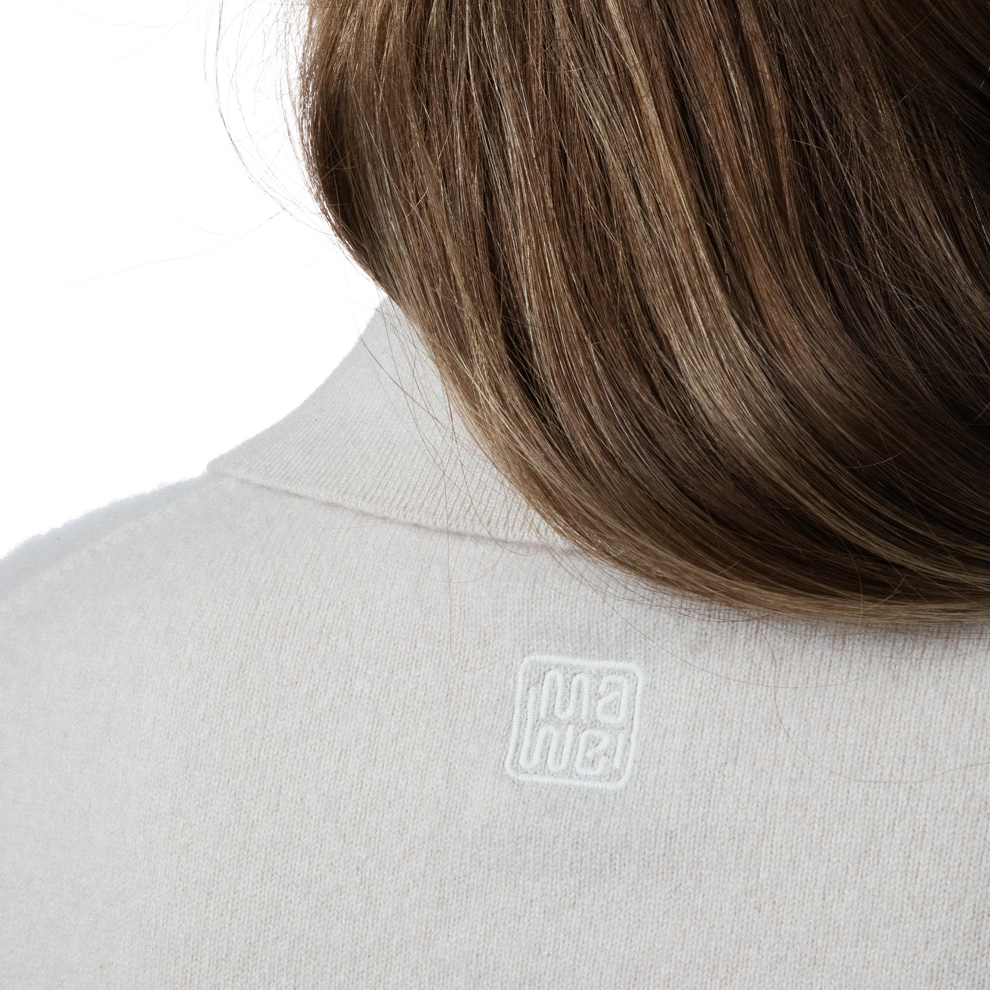 MA09 Cashmere Short Sleeve Polo Sweater by Mawei, off white, female model, collar, embroidery details, back view.