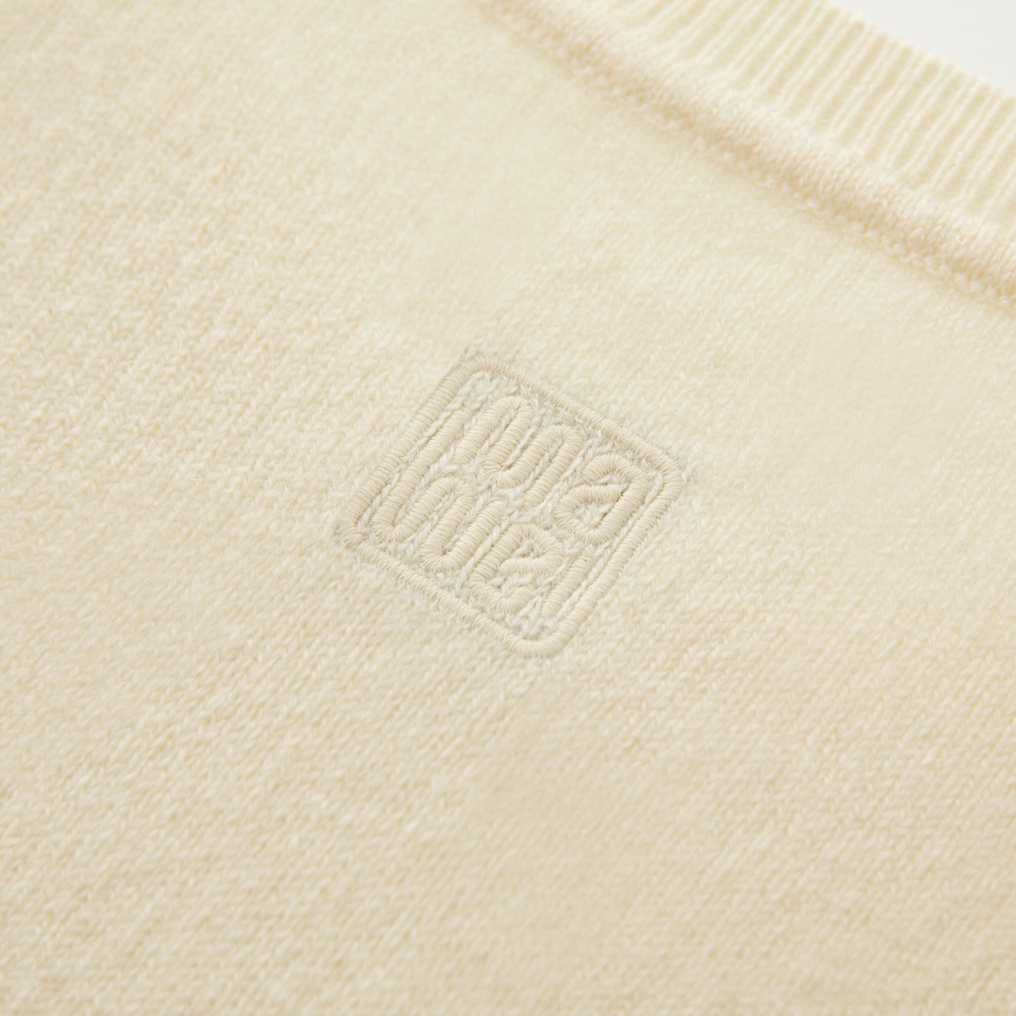 MA01 Cashmere Sleeveless Crewneck Sweater by Mawei, yellow cream, fabric and logo embroidery close up, back view