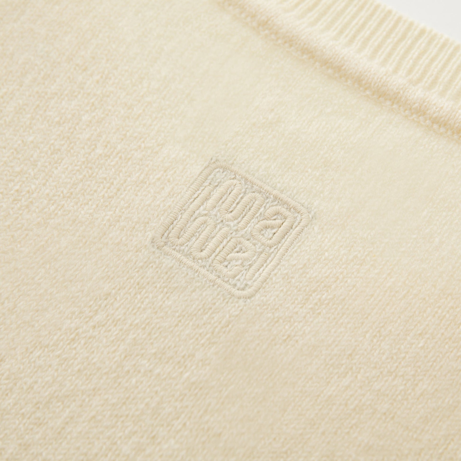 MA01 Cashmere Sleeveless Crewneck Sweater by Mawei, yellow cream, fabric and logo embroidery close up, back view