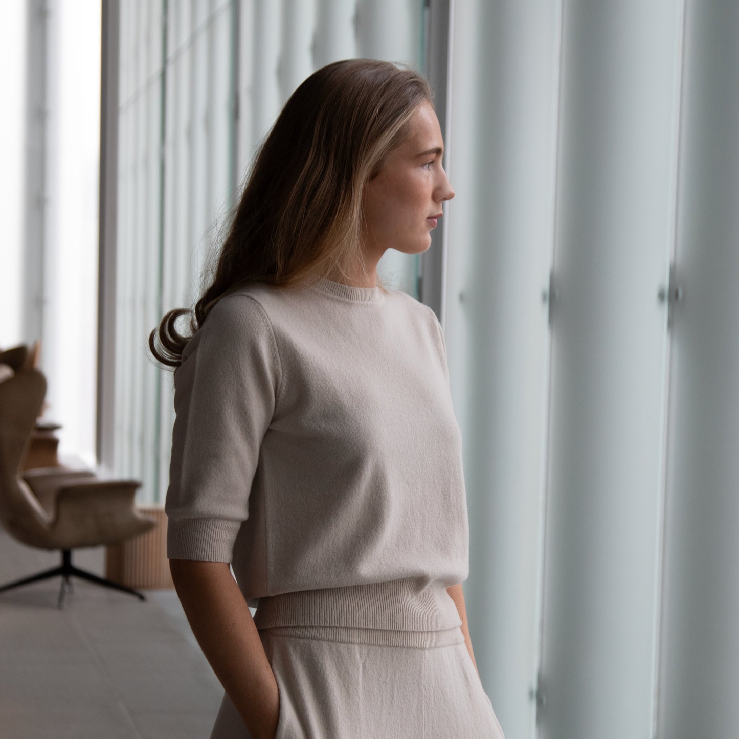 MA03 Cashmere Short Sleeve Crewneck Sweater by Mawei, off white, side view, female model.