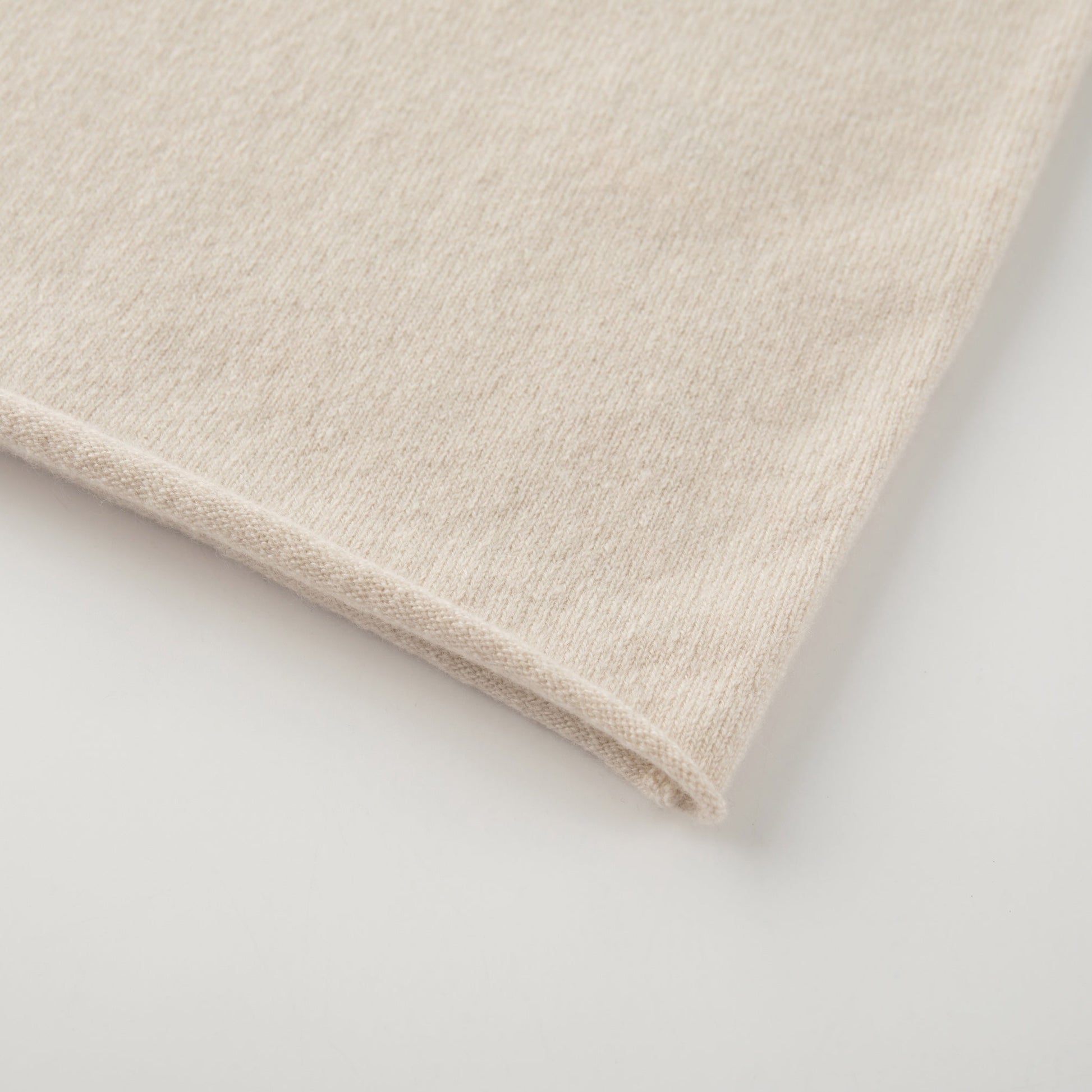 MA04 Short Sleeve Cashmere Tee with Pocket by Mawei, off white, bottom rolled edge close up.