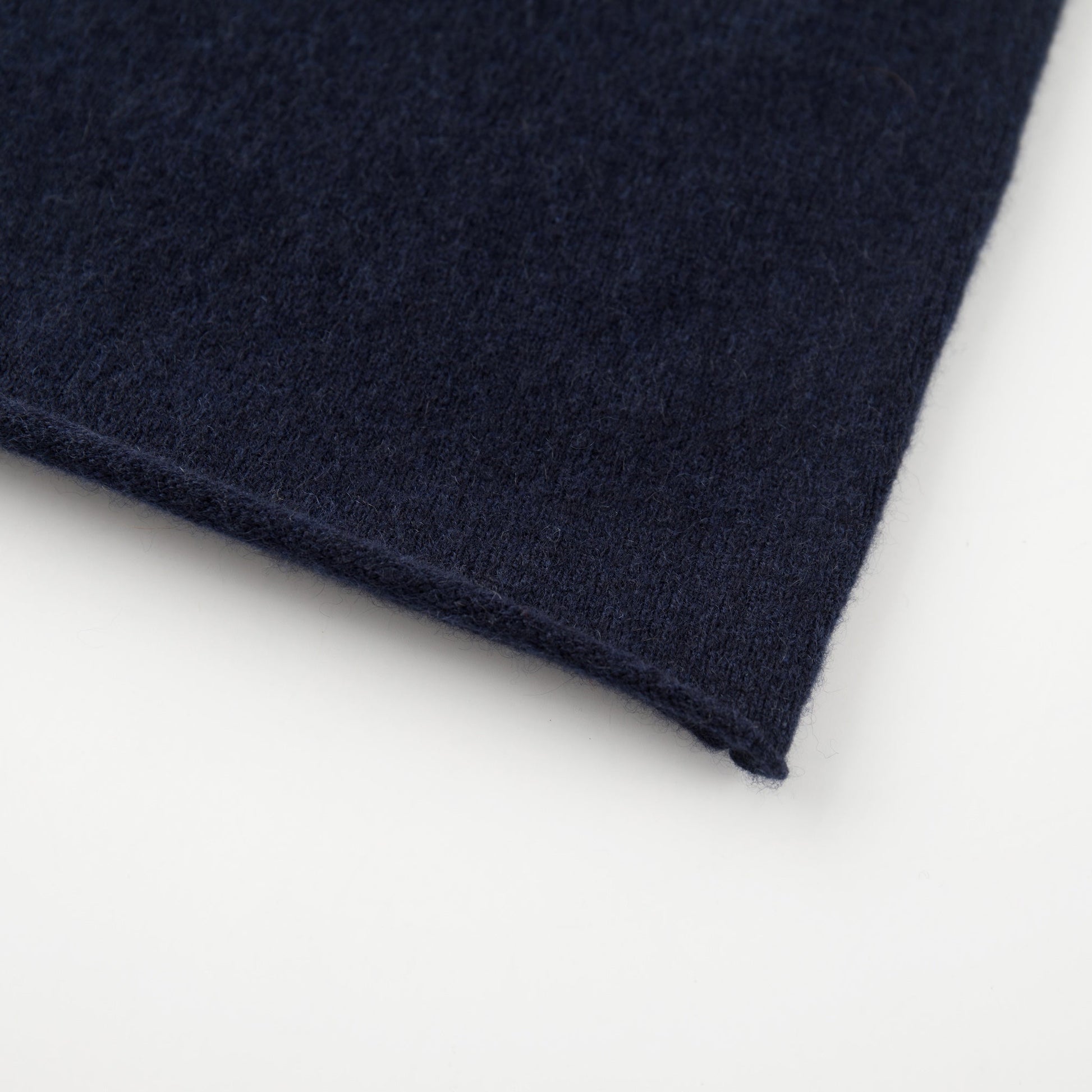 MA04 Short Sleeve Cashmere Tee with Pocket by Mawei, navy blue, bottom rolled edge close up.