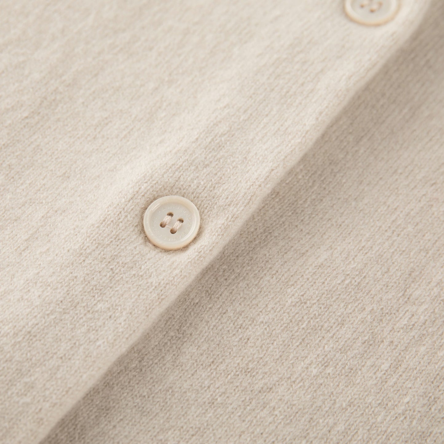 MA06 Cashmere Crewneck Cardigan by Mawei, off white, buttons detail close-up.