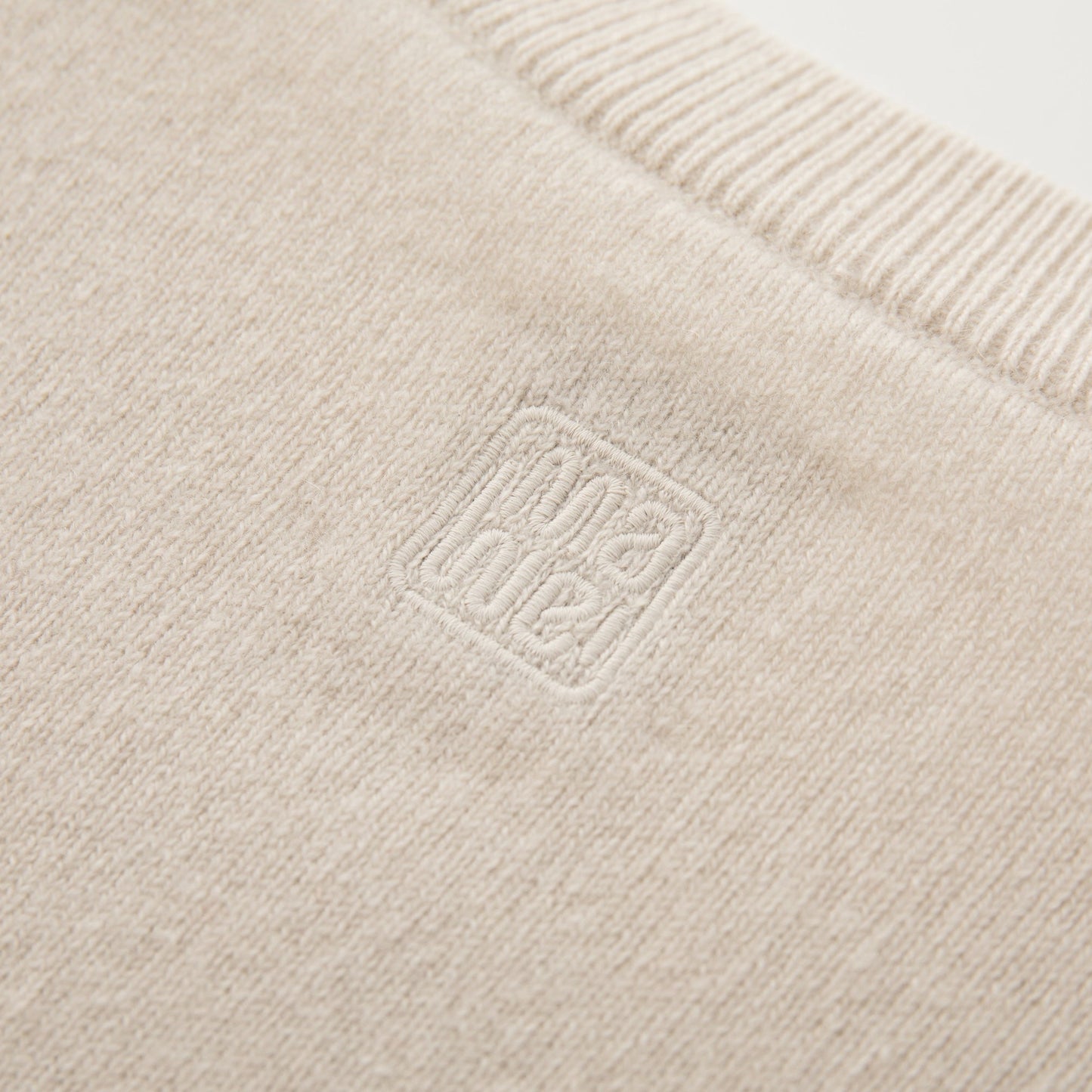 MA06 Cashmere Cardigan by Mawei, off white, fabric and logo embroidery close-up, back view.