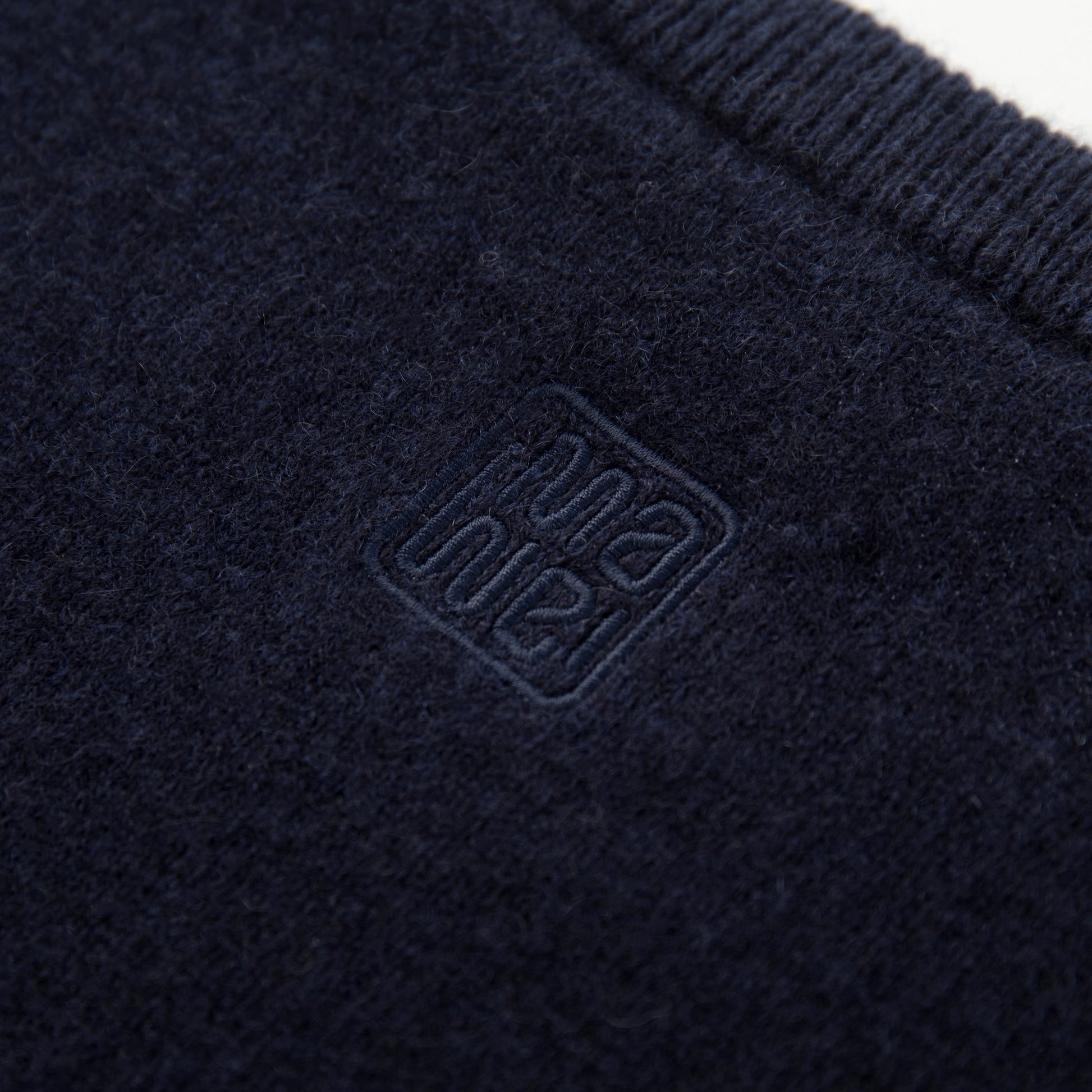 MA07  Cashmere Short Sleeve Crewneck  Sweater by Mawei, navy blue, fabric and logo embroidery  close-up, back view.