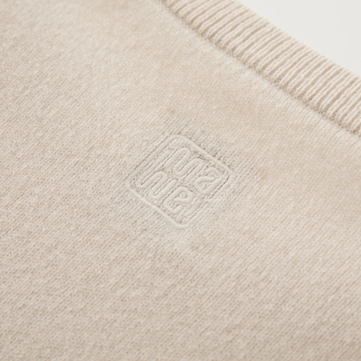 MA07  Cashmere Short Sleeve Crewneck  Sweater by Mawei, off white, fabric and logo embroidery  close-up, back view.