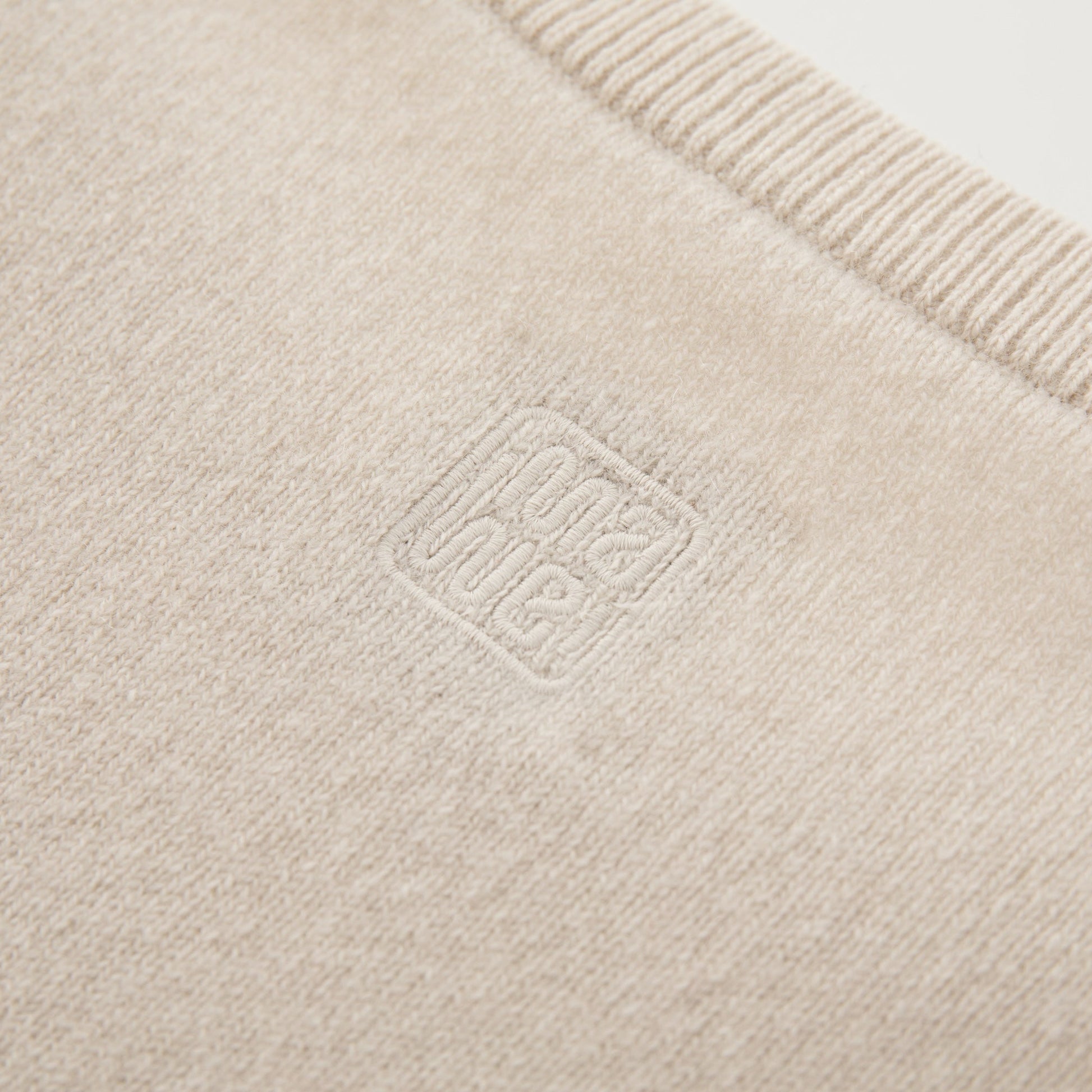MA07  Cashmere Short Sleeve Crewneck  Sweater by Mawei, off white, fabric and logo embroidery  close-up, back view.