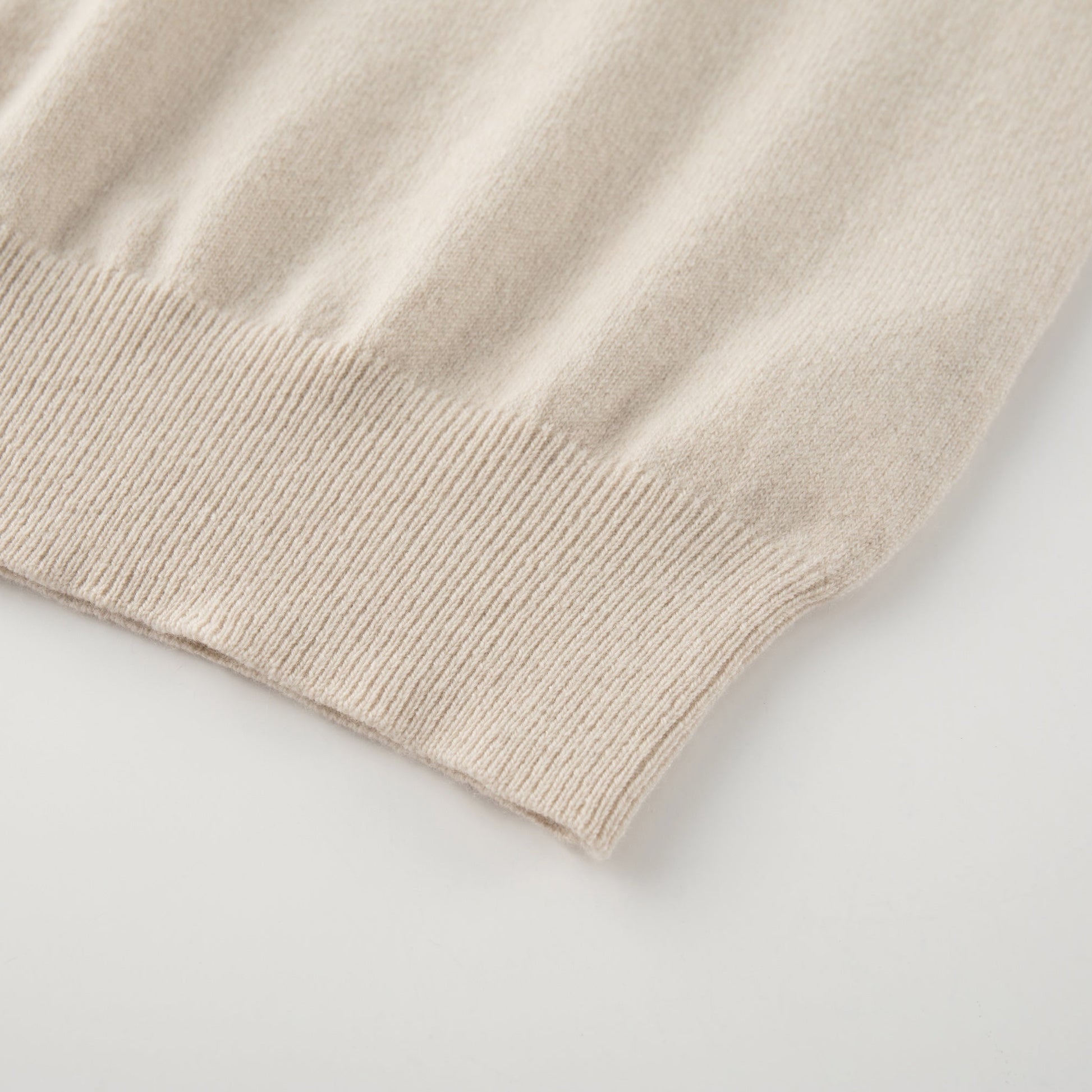 MA09 Cashmere Short Sleeve Polo Sweater by Mawei, off white, hem rib close up.