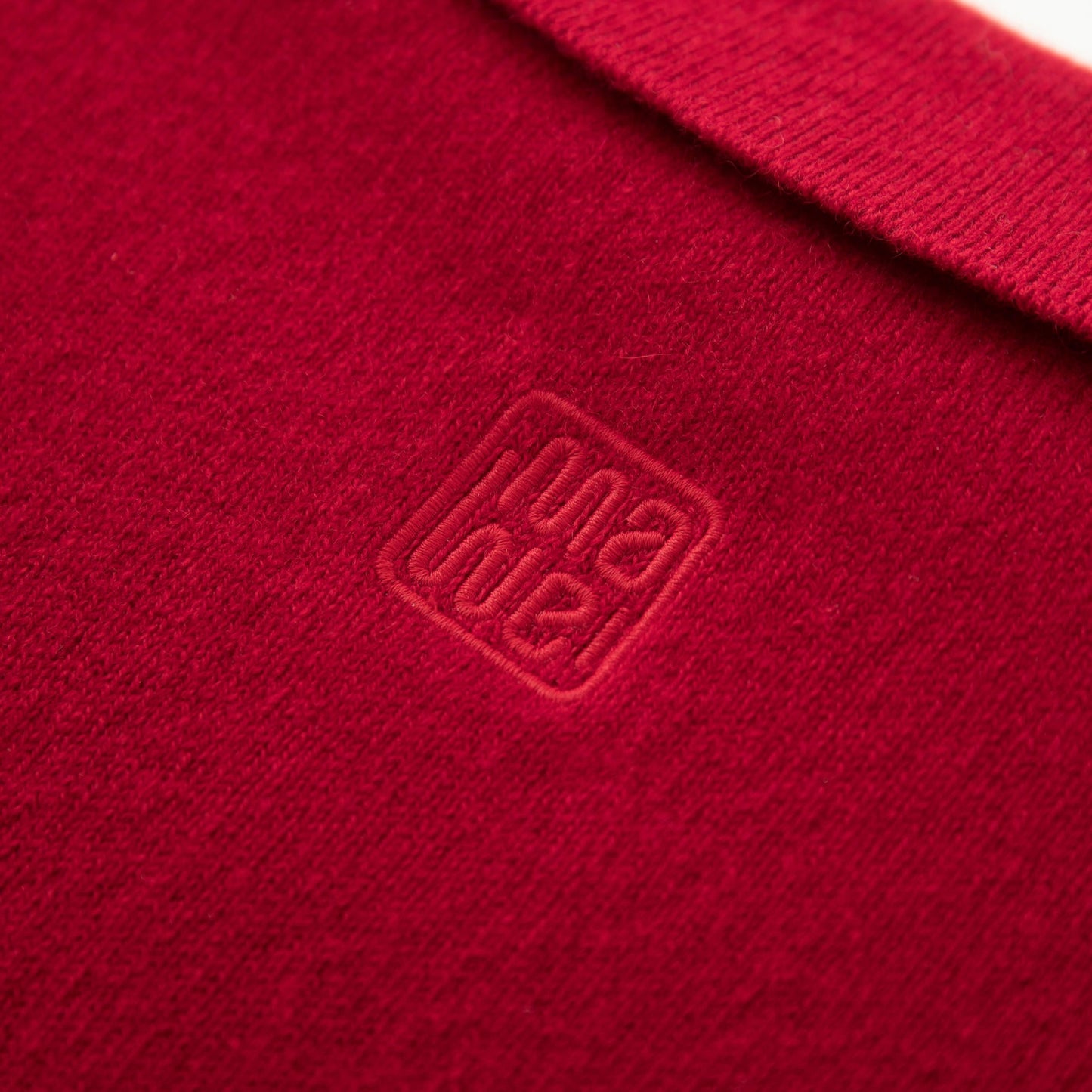 MA09 Cashmere Short Sleeve Polo Sweater by Mawei, red, fabric and logo embroidery close up, back view.