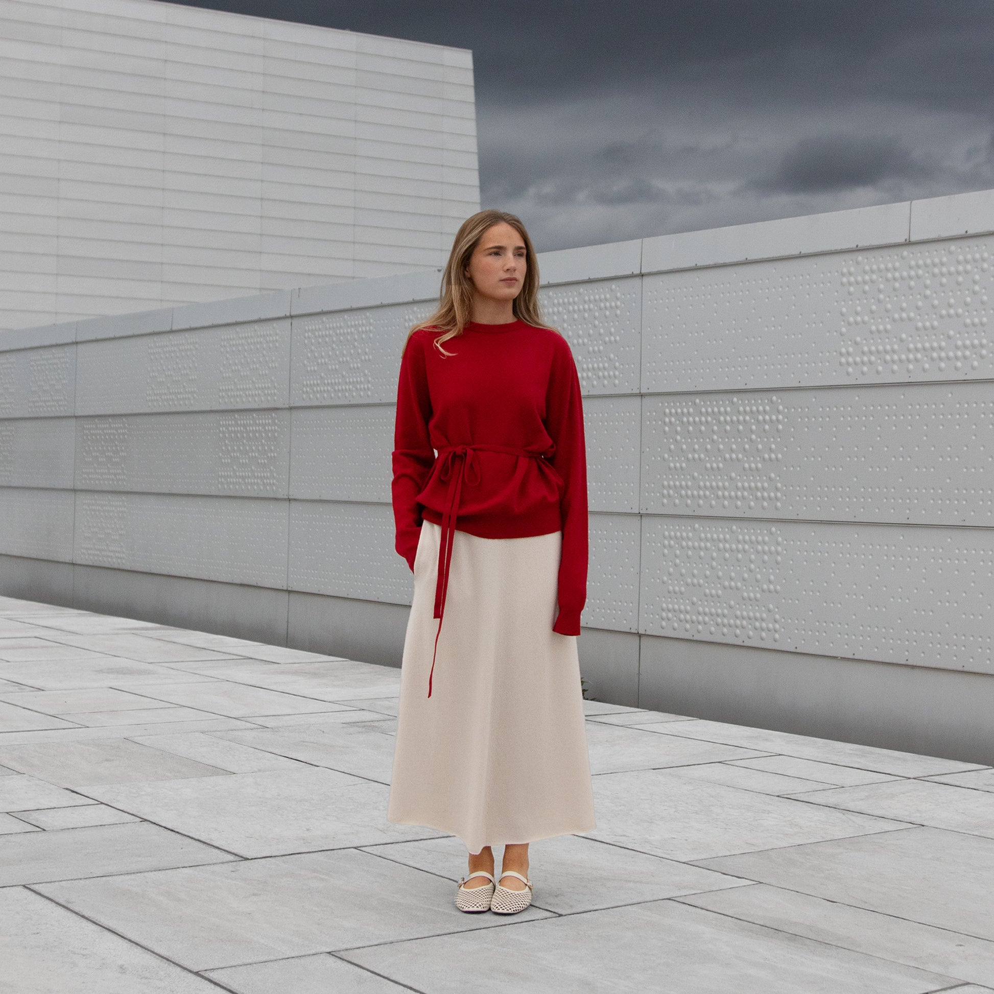 MA34 Cashmere A‑Line Skirt, off white and MA22 Cashmere Crewneck Sweater, red, by Mawei, front view, female model.