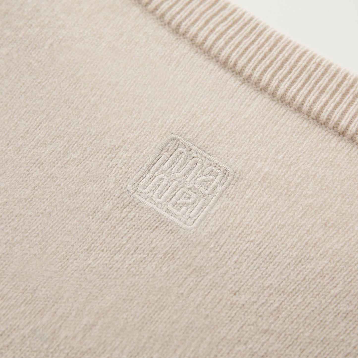 MA22 Cashmere Crewneck Sweater by Mawei, off white, fabric and embroidery detail close-up.
