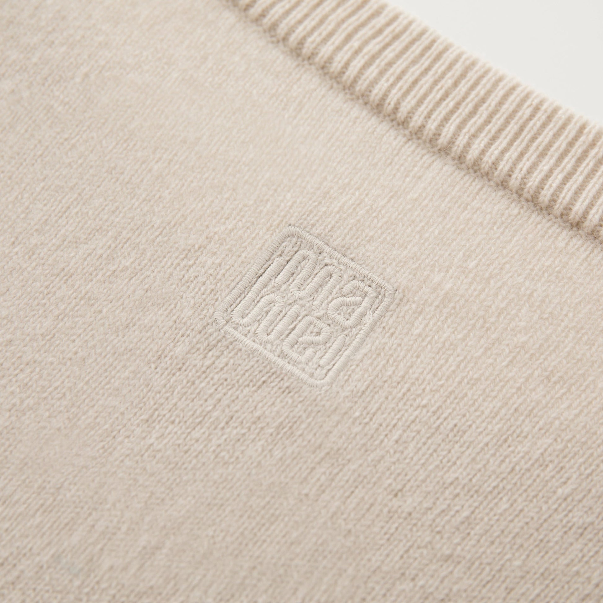 MA22 Cashmere Crewneck Sweater by Mawei, off white, fabric and embroidery detail close-up.