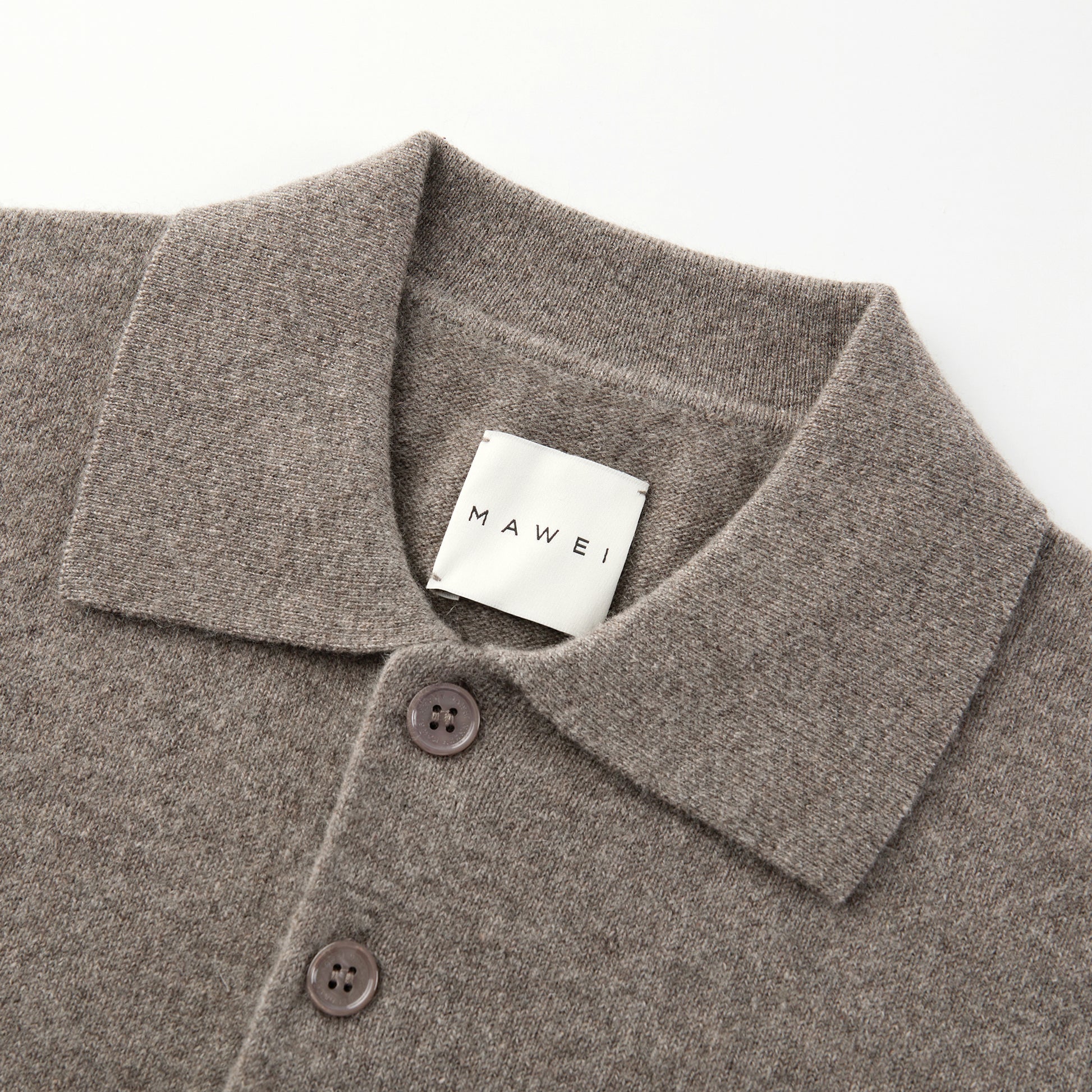 MA25 Cashmere Polo Sweater by Mawei, grey-brown, fabric texture, buttons, collar details close-up.