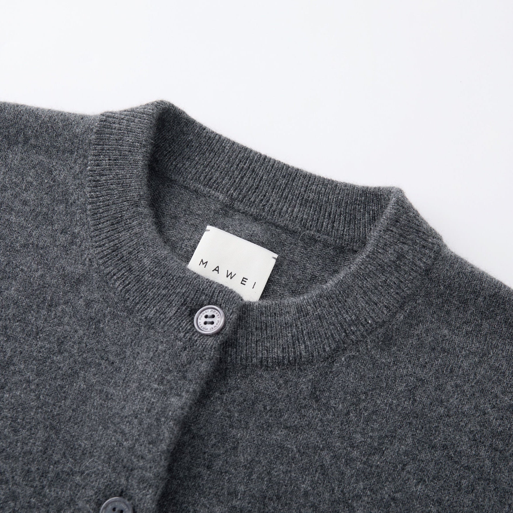 MA06 Cashmere Crewneck Cardigan by Mawei, grey,  neck, rib, button details close-up.